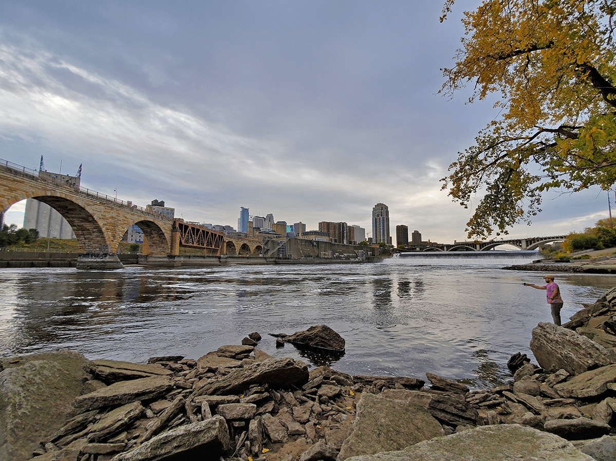 Angler and lower water level river