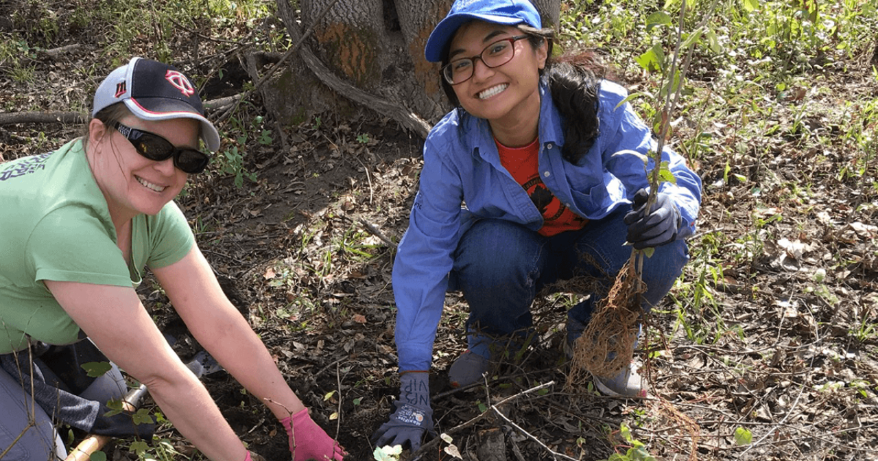 Intern Phuong Nyugen at a planting event Intern planting tree