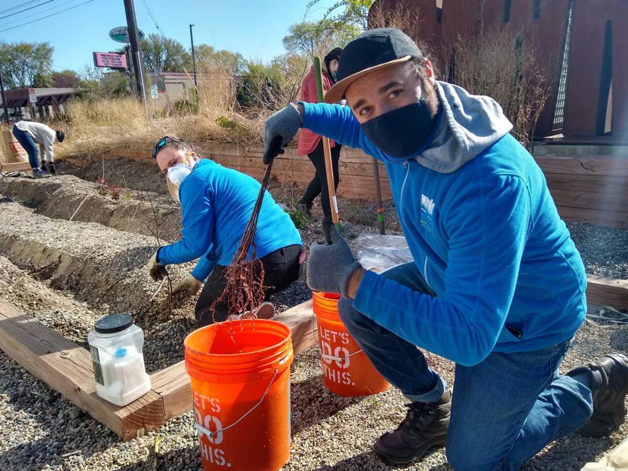 MWMO planting MWMO staff planting trees in their gravel bed