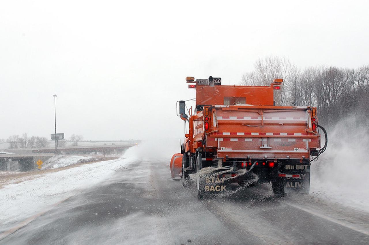 Road salt Truck applies road salt to icy roads