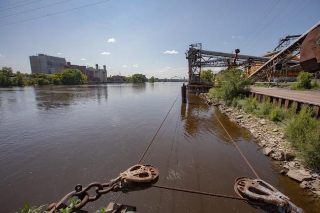 A river, with industrial structures on both shorelines.